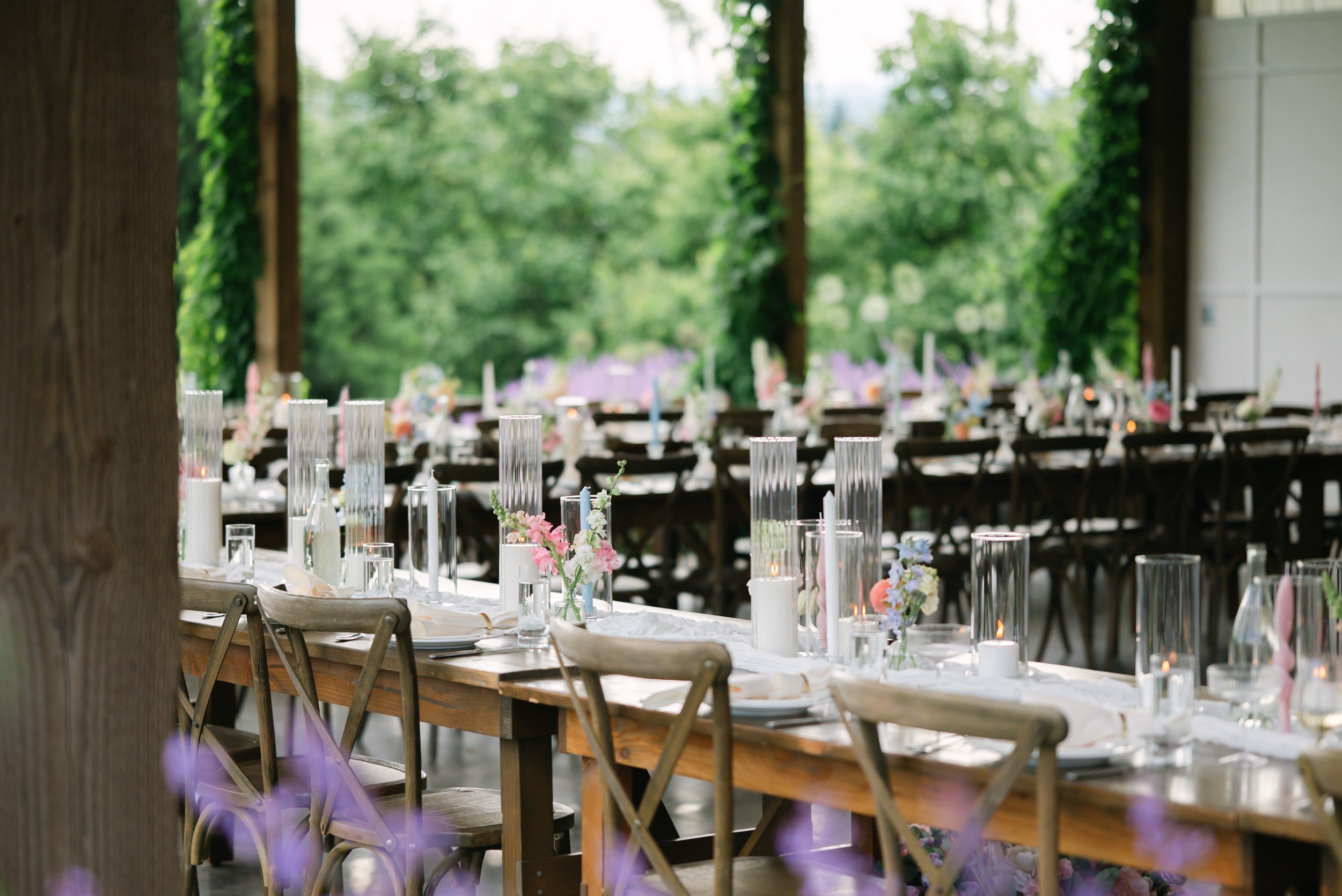 Elegant wedding reception tablescape with layered place settings and refined floral details