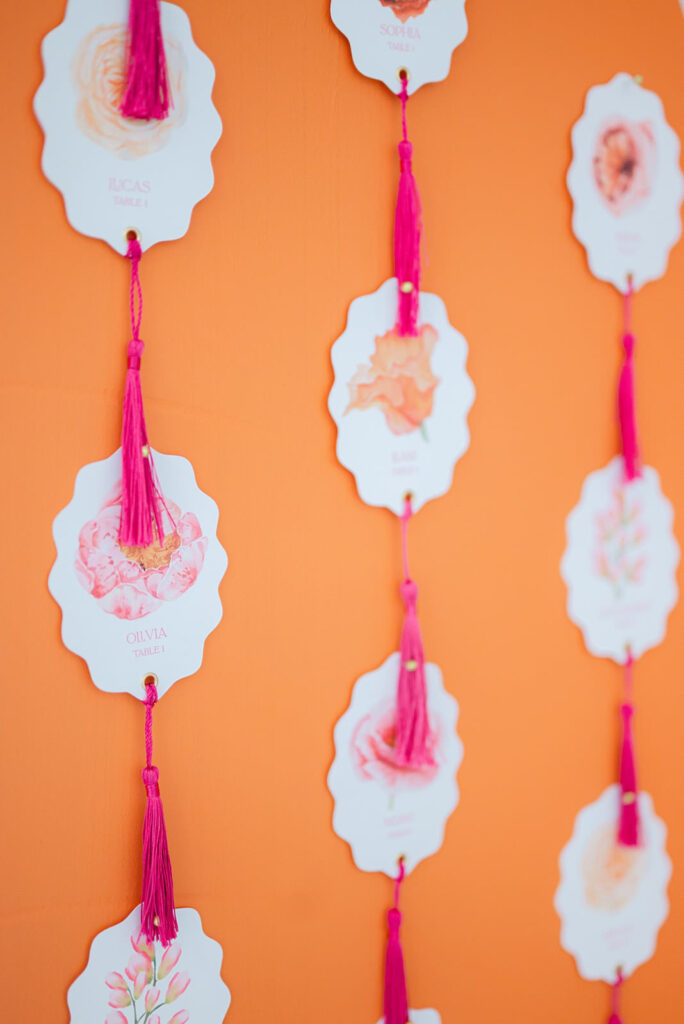 Wedding guest chart with playful tags displayed at a sunrise-inspired wedding at Sandy River Gardens in Troutdale, Oregon