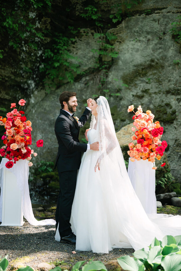 Bride and groom cheering after their ceremony kiss at Sandy River Gardens in Troutdale, Oregon
