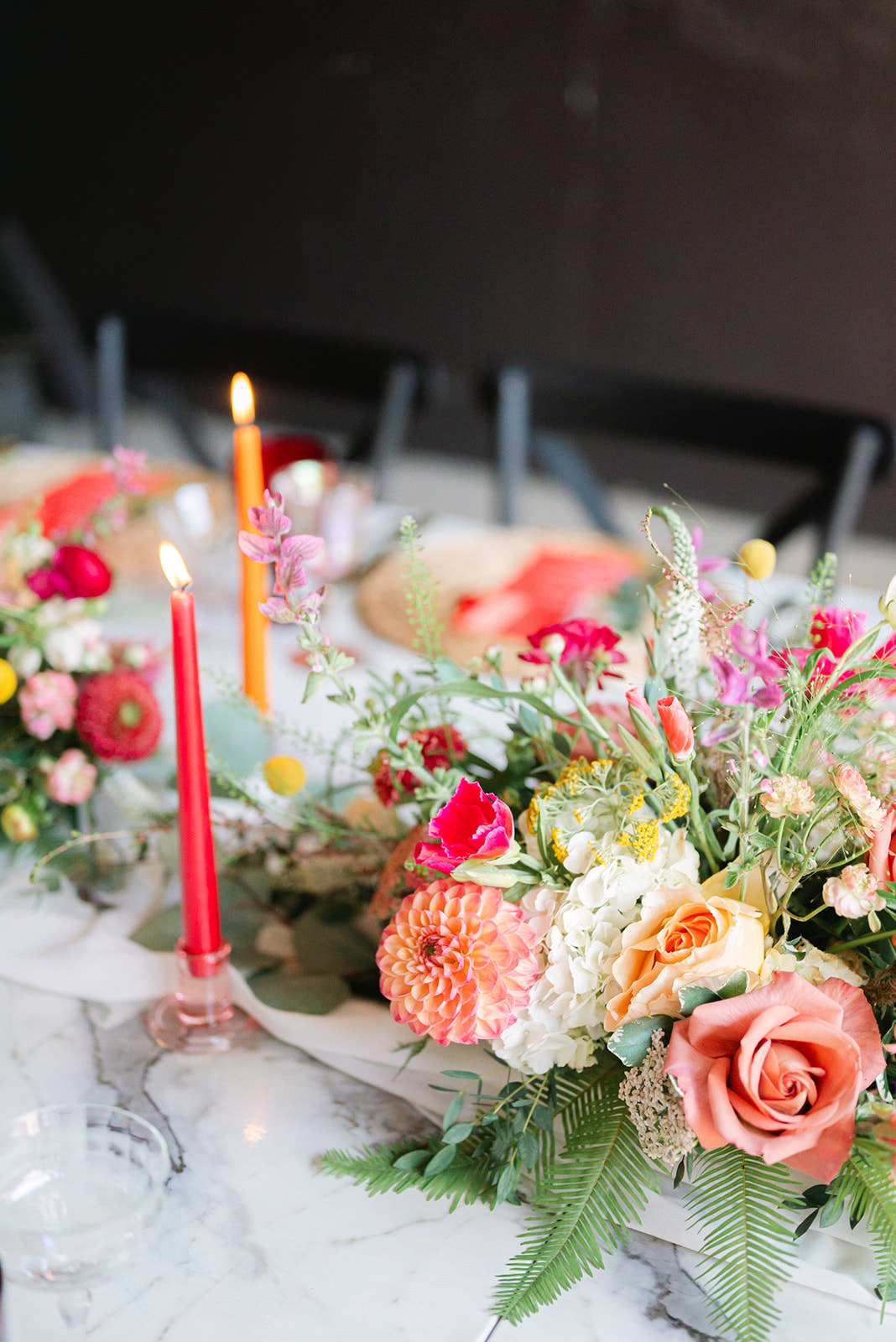 Colorful sunrise wedding florals in shades of red, orange, pink, and white photographed beautifully in a North Carolina wedding setting.