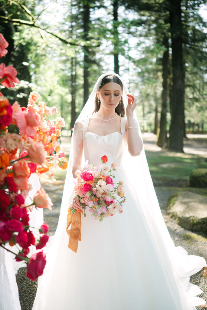 Upper-body bridal portrait featuring a bouquet at Sandy River Gardens in Troutdale, Oregon