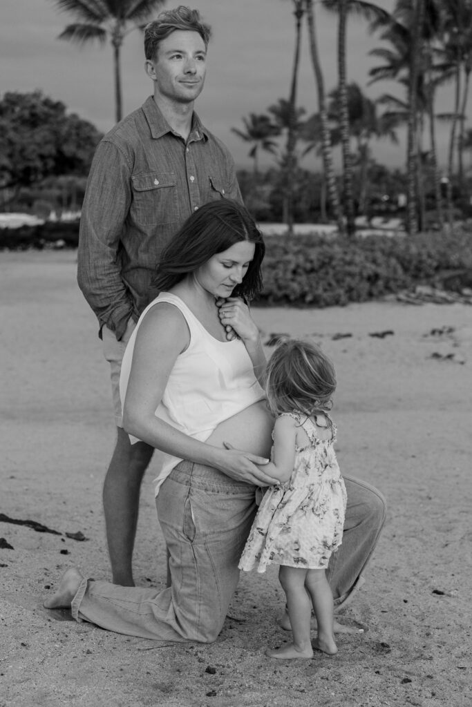 Pregnant mother with her husband and young daughter