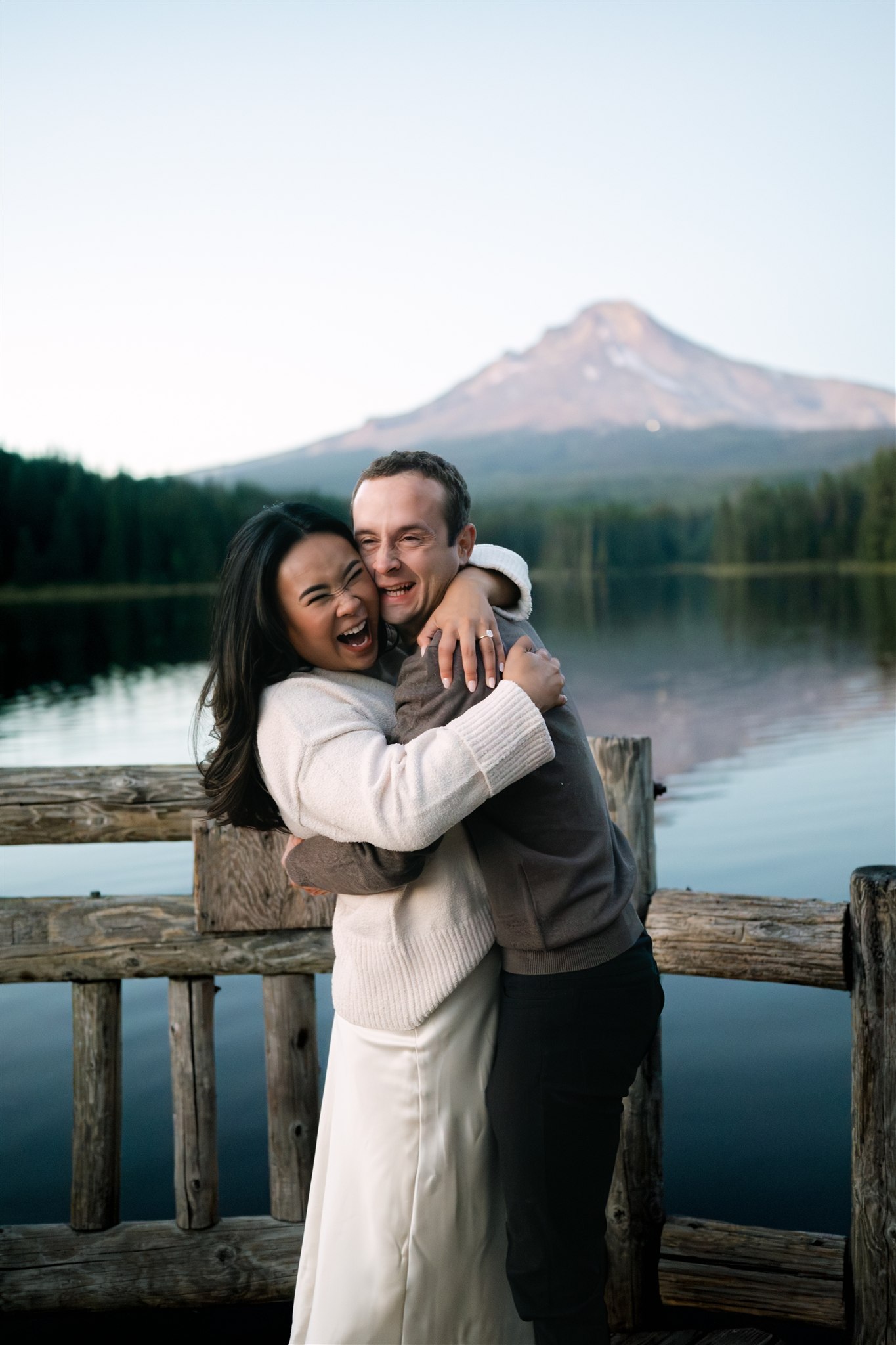 Close-up of a couple laughing and pressing their cheeks together during a fun engagement session