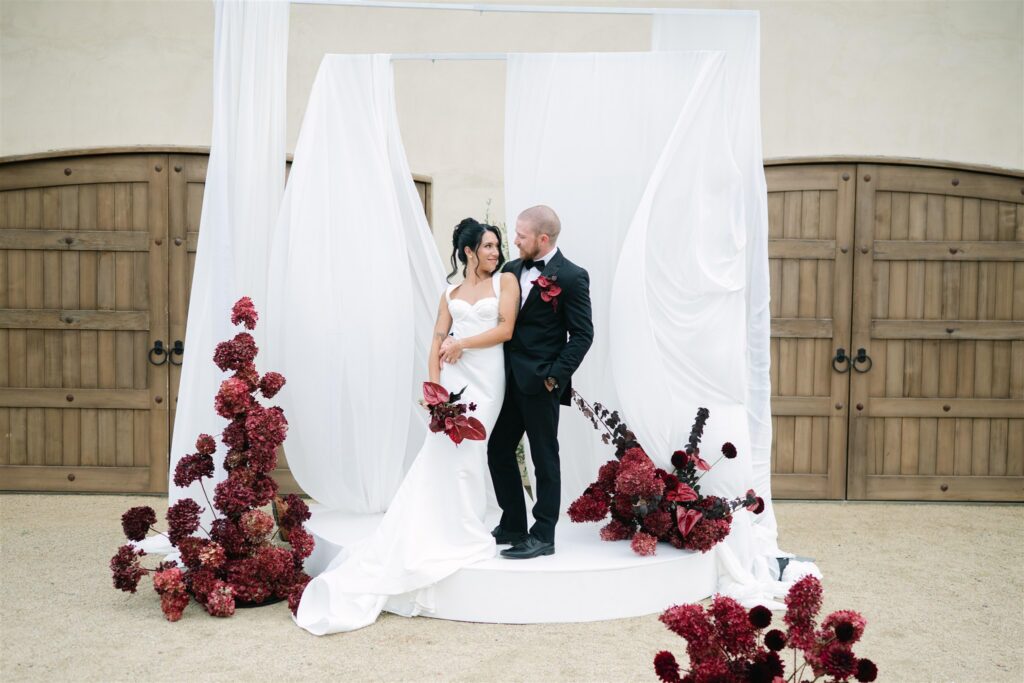 Bride and groom posing for a portrait at a chateau ceremony space, captured in a refined documentary wedding style
