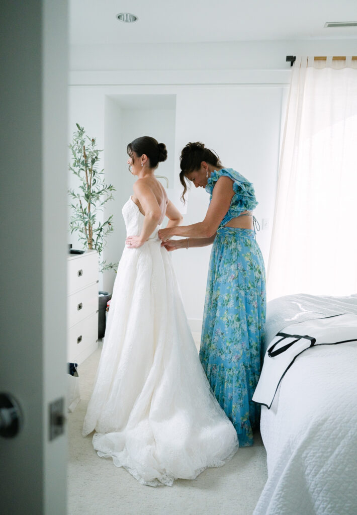 Mother of the Bride Getting Ready at Bay Harbor Mother of the bride having her dress buttoned in the getting-ready suite before a Bay Harbor wedding on Lake Michigan